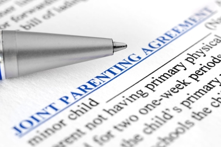 Close-up of Joint parenting agreement with pen